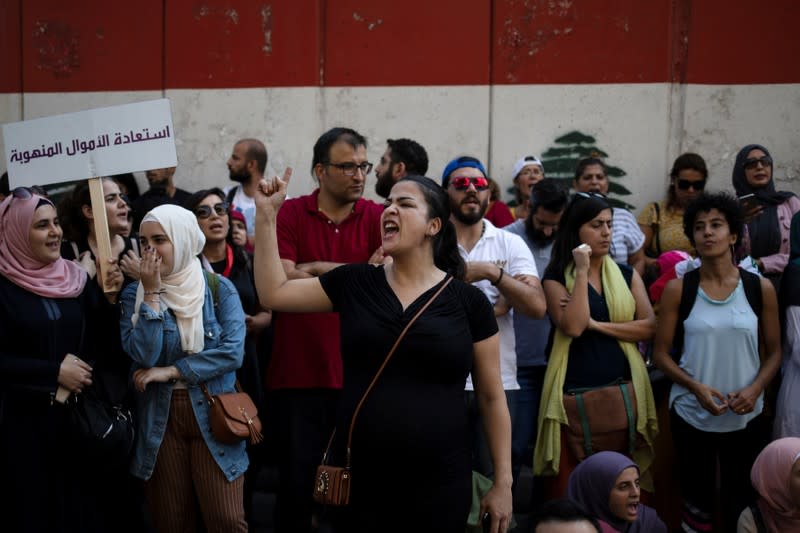 Demonstrators shout slogans during an anti-government protest outside the Central Bank of Lebanon in Beirut