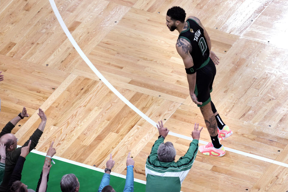 Fans celebrate after a basket by Boston Celtics forward Jayson Tatum (0) during the second half of Game 2 of the NBA Finals basketball series against the Dallas Mavericks, Sunday, June 9, 2024, in Boston. (AP Photo/Michael Dwyer)