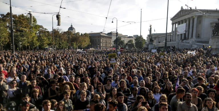 Protesters gather in front of the Austrian parliament during a pro-Asylum demo to welcome refugees in Vienna on October 3, 2015