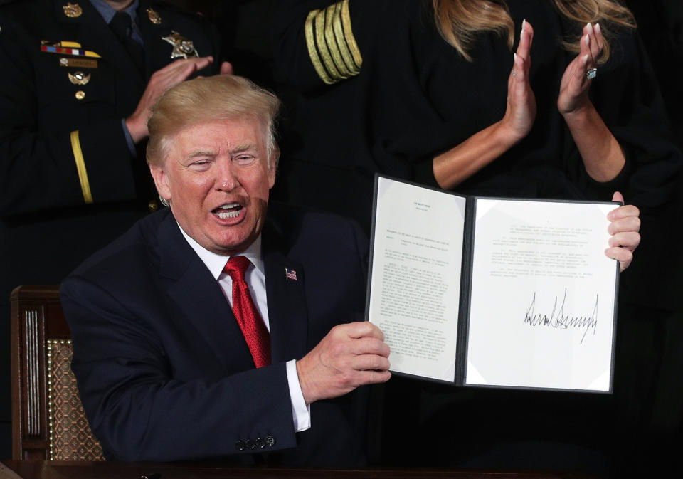 U.S. President Donald Trump shows a presidential memorandum that he signed during an event highlighting the opioid crisis in the U.S. October 26, 2017 in the East Room of the White House in Washington, DC. He signed the bipartisan opioid legislation two days prior. (Photo: Alex Wong/Getty Images)