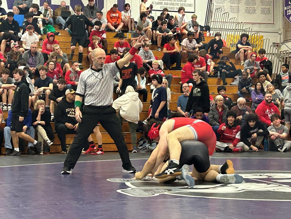 Mike Ahern works at a recent JV jamboree meet at Cherry Hill West High School on Saturday. After a standout career as a wrestler and a coach, Ahern is a first-year official.