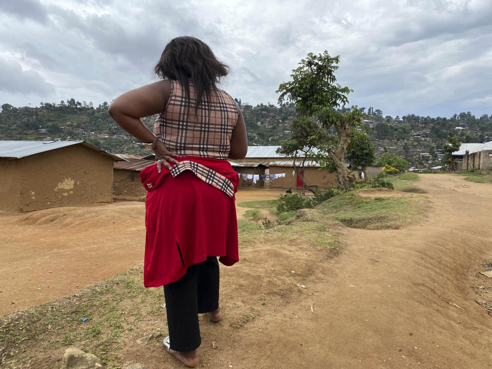 FILE - In this Thursday, March 18, 2021 file photo, Shekinah stands near her home in Beni, eastern Congo. Internal documents obtained by The Associated Press show that the World Health Organization has paid $250 each to at least 104 women in Congo who say they were sexually abused or exploited by Ebola outbreak responders. That amount is less than what some U.N. officials are given for a single day’s expenses when working in Congo. (AP Photo/Kudra Maliro, File)