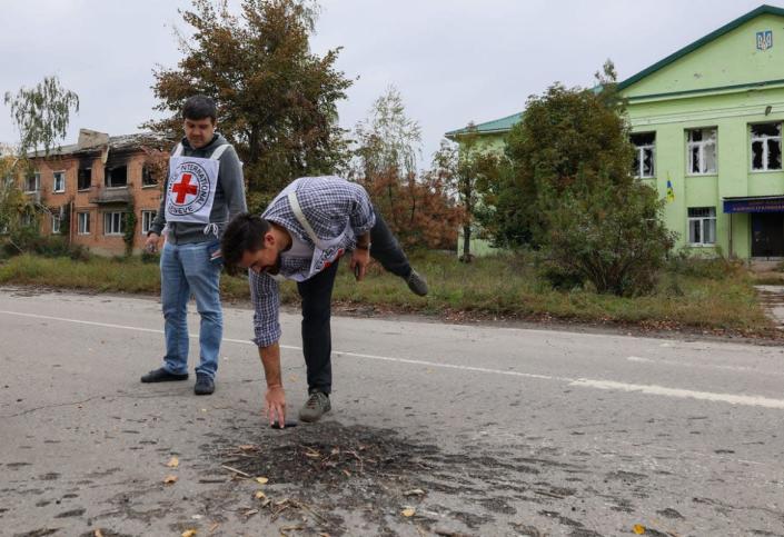 <div class="inline-image__caption"><p>Volunteers examine the remnants of a shell explosion in the town of Staryy Saltiv, Kharkiv region.</p></div> <div class="inline-image__credit">Anadolu Agency/Getty</div>