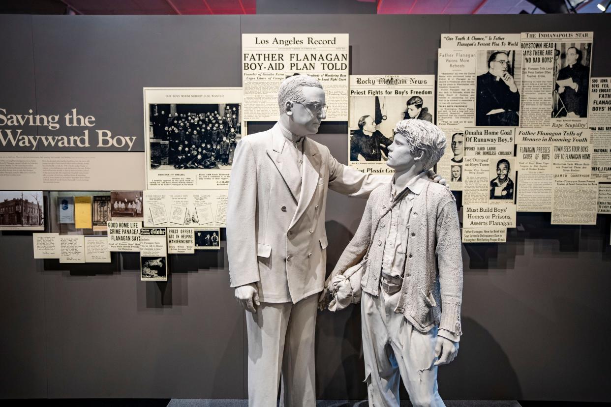 A statue of Father Flanagan with a boy on display at the Boys Town Hall of History, Thursday, Aug. 3, 2023.