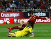 Spain's Alvaro Morata (top) kicks the ball to score next to Ukraine's Yevhen Khacheridi during their Euro 2016 qualifier soccer match at Ramon Sanchez Pizjuan stadium in Seville, March 27, 2015. REUTERS/Marcelo del Pozo