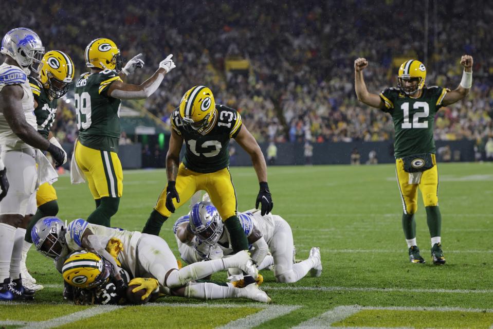 Green Bay Packers' Aaron Rodgers celebrates a touchdown run by Aaron Jones during the second half of an NFL football game against the Detroit Lions Monday, Sept. 20, 2021, in Green Bay, Wis. (AP Photo/Mike Roemer)