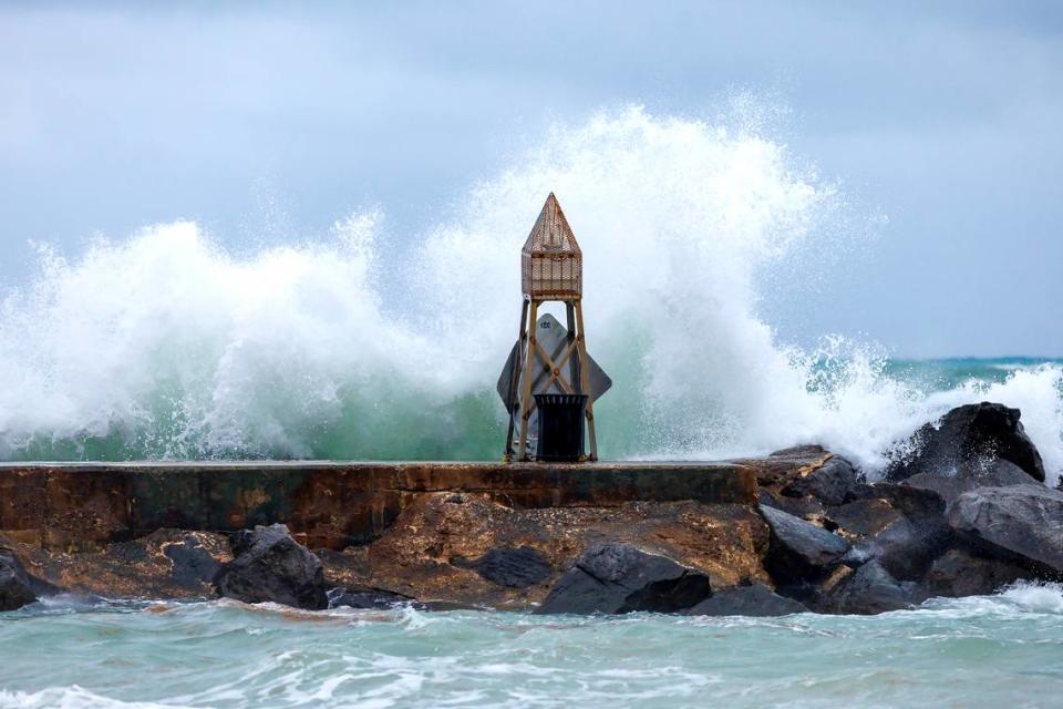 Waves crash against the jetty at the Bal Harbour Lighthouse on Wednesday, April 12, 2023, in Bal Harbour, Florida. Rip current risk remains in effect through Thursday evening.