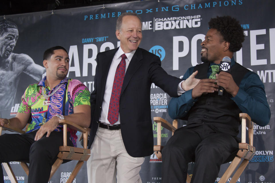 Jim Gray (C), shown here between Danny Garcia and Shawn Porter at a July 2018 news conference, is an integral part of Showtime’s boxing broadcasts. (Getty Images)