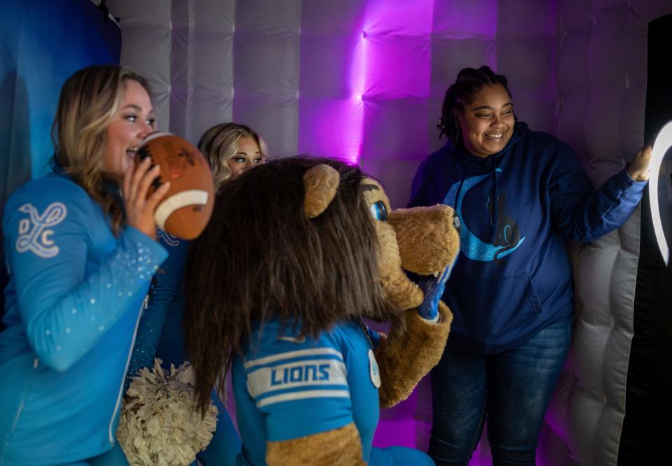 Nicole, left, Natalie, and Detroit Lions mascot Roary smile as Taylor Small takes their photo inside the Heilmann Recreation Center during the On The Clock Tour event in Detroit on Saturday, Feb. 24, 2024. The city of Detroit and Visit Detroit, in conjunction with the Detroit Sports Commission and local grassroots partners, brought the event together ahead of the 2024 NFL draft in Detroit.