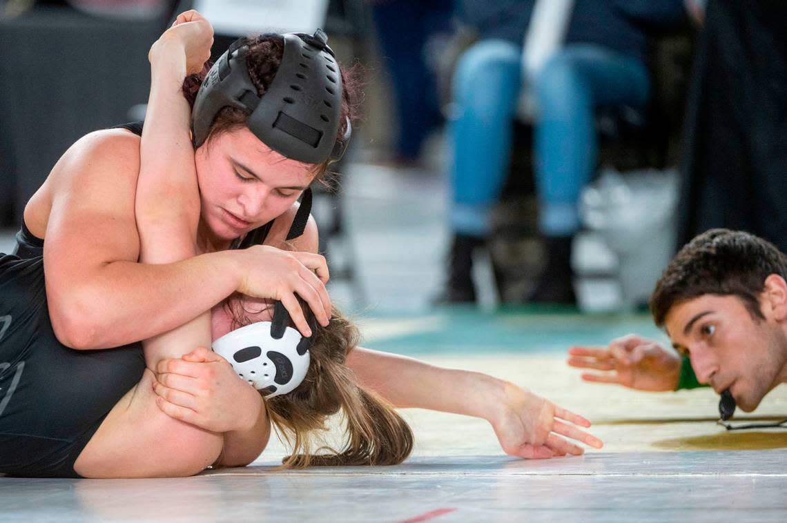 Curtis’ Clarissa Wangen pushes down on the face of Bellingham’s Frances Porteous just before the Wangen’s pin during the 155-pound, Girls 3A/4A division championship match at Mat Classic XXXIV on Saturday, Feb. 18, 2023, at the Tacoma Dome in Tacoma, Wash.