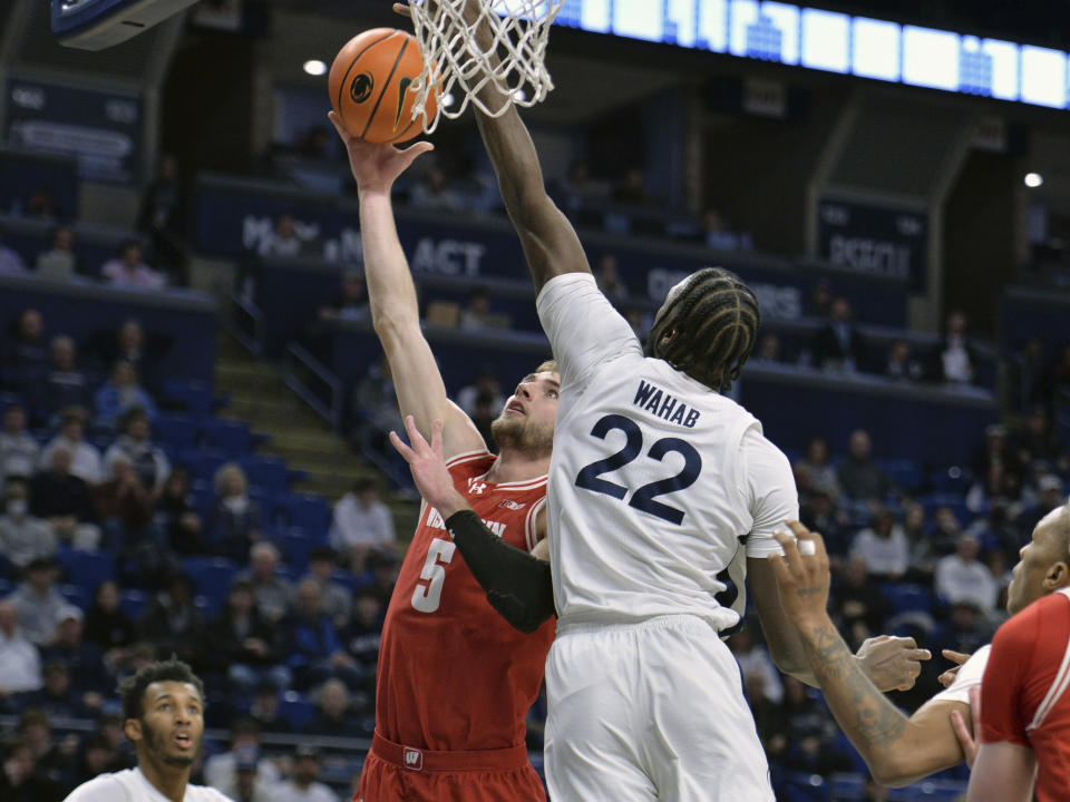 Wisconsin's Tyler Wahl (5) goes to the basket against Penn State's Qudus Wahab (22) during the first half of an NCAA college basketball game Tuesday, Jan. 16, 2024, in State College, Pa. (AP Photo/Gary M. Baranec)