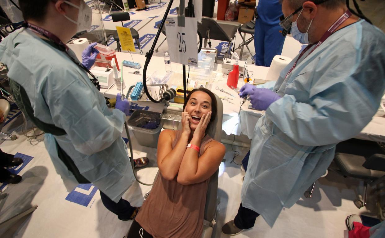 Elizabeth Burchell jokes with dentists Travis Nixon and Josh Grimes before having all four wisdom teeth extracted as the North Carolina Missions of Mercy Foundation held a free adult dental clinic Friday, Aug. 19, 2022, at City Church in Gastonia.