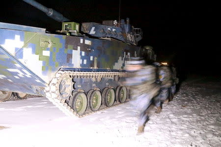 Soldiers of the People's Liberation Army (PLA) Marine Corps are seen in training at a military training base in Xinjiang Uighur Autonomous Region, January 11, 2016. REUTERS/CNS Photo