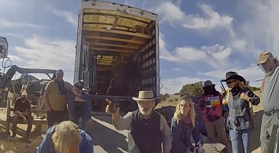 In this image from video released by the Santa Fe County Sheriff's Office, Alec Baldwin gestures while talking with investigators following a fatal shooting last year on a movie set in Santa Fe, New Mexico. Law enforcement officials have released a trove of video and photographic evidence in the investigation of a fatal October shooting of a cinematographer by actor and producer Alec Baldwin on the set of a Western movie. Data files released by the Santa Fe County Sheriff's Office on Monday, April 25, 2022, included videos of investigators debriefing Baldwin on the day of the shooting inside a compact office. (Santa Fe County Sheriff's Office via AP)