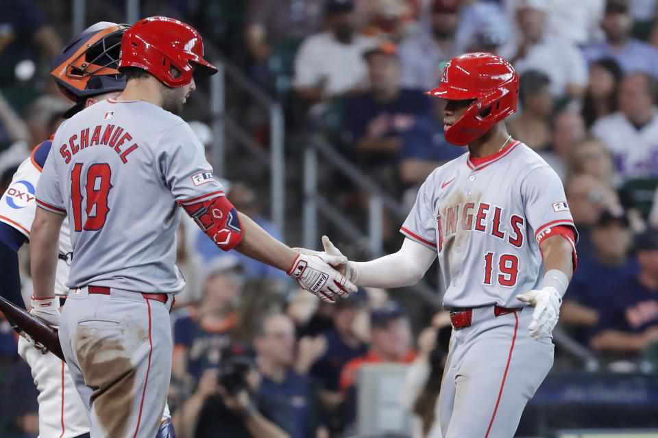 Los Angeles Angels' Nolan Schanuel, left, and Kyren Paris, right, celebrate the two-run home run by Paris against the Houston Astros during the fifth inning of a baseball game Wednesday, May 22, 2024, in Houston. (AP Photo/Michael Wyke)