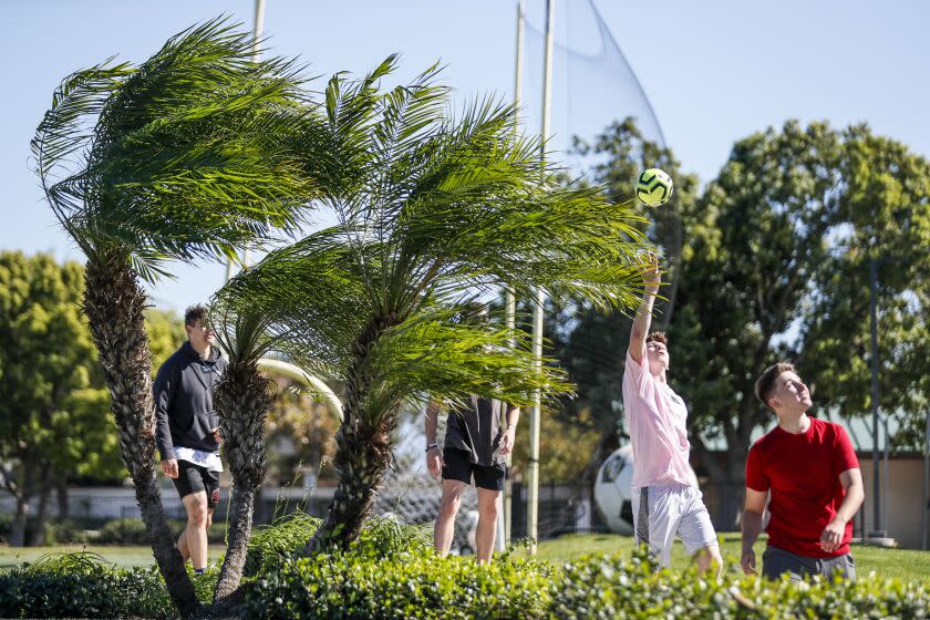 Fontana, CA, Monday, October 24, 2022 - Friends gather for a touch football game on a windy day at the Ralph M. Lewis Sports Complex. (Robert Gauthier/Los Angeles Times)