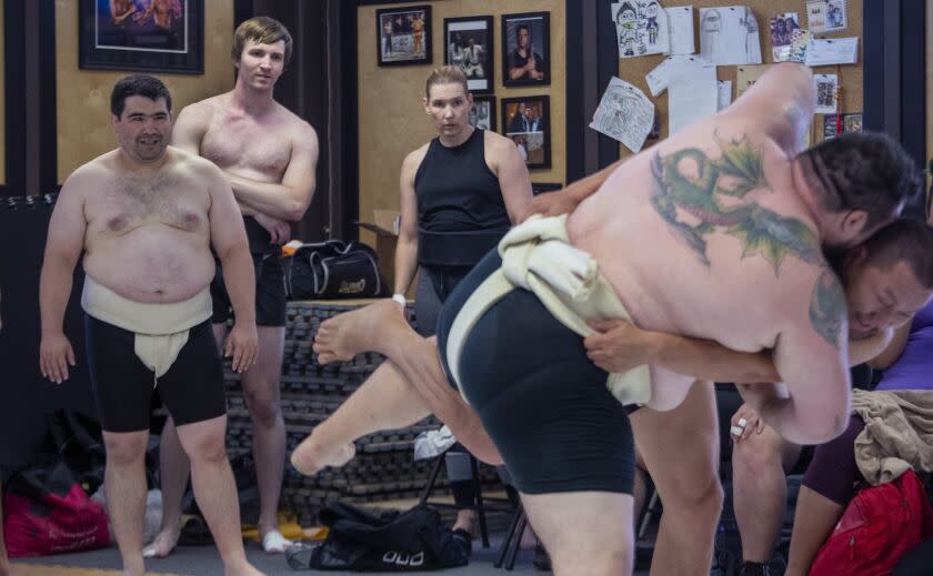 Torrance, CA - August 14 Jenni Crook, top right, and her son Josh Crook, top left, watch sumo wrestlers practice