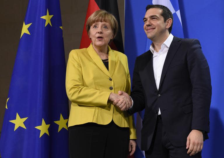 German Chancellor Angela Merkel and Greek Prime Minister Alexis Tsipras pose for photographers after a press conference at the chancellery in Berlin, on March 23, 2015