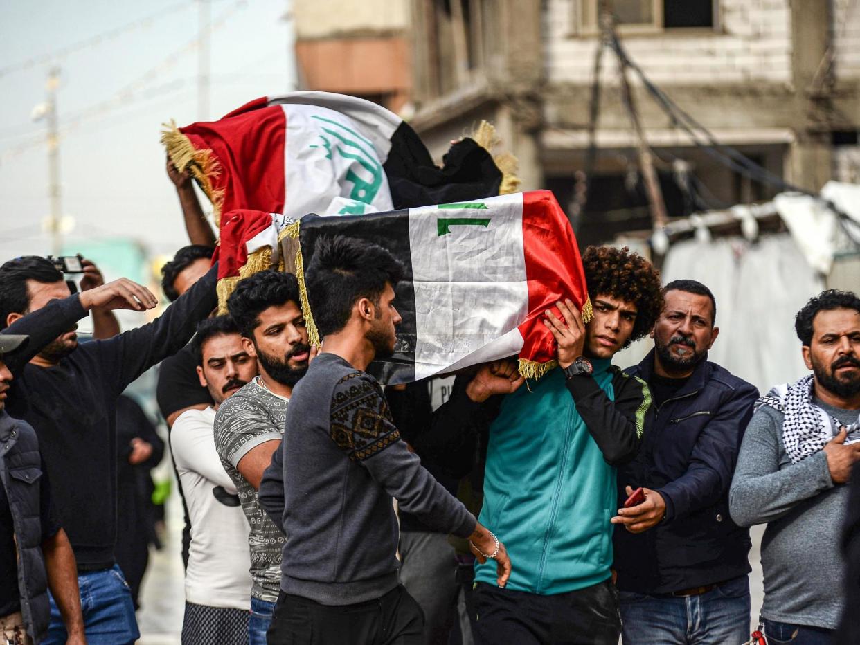 Mourners carry the coffin of a driver who was killed during clashes between anti-government protesters and security forces in Baghdad: Getty
