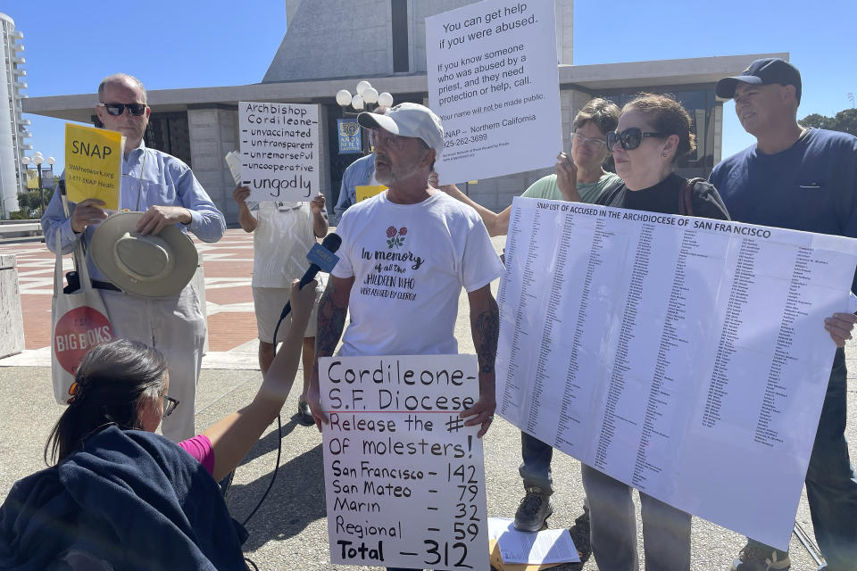 Joey Piscitelli, a member of Northern California SNAP, the Survivors Network of those Abused by Priests, middle, speaks outside of St. Mary's Cathedral in San Francisco, Thursday, Sept. 29, 2022. (AP Photo/Haven Daley)