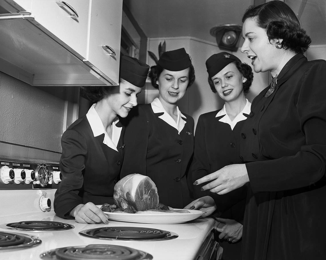 Feb. 23, 1951: American Airlines hostesses are shown as they get a preview from Martha Logan, right, of the techniques that she would introduce at the first session of the Leonard’s Department Store’s 10-day cooking school. The hostesses are, left to right, Sally Hudson, Betty Burnett and Jean Hill.