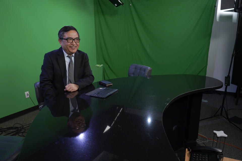 Chinese dissident Ho Pin poses for a portrait in the television studio of the Mirror Media Group during an interview with The Associated Press, Thursday, Oct. 6, 2022, in Great Neck, N.Y. Ho said that considering Xi Jinping's consolidation of power, there is little point in predicting the next leadership line up, just days before the annual Communist Party congress. (AP Photo/Mary Altaffer)