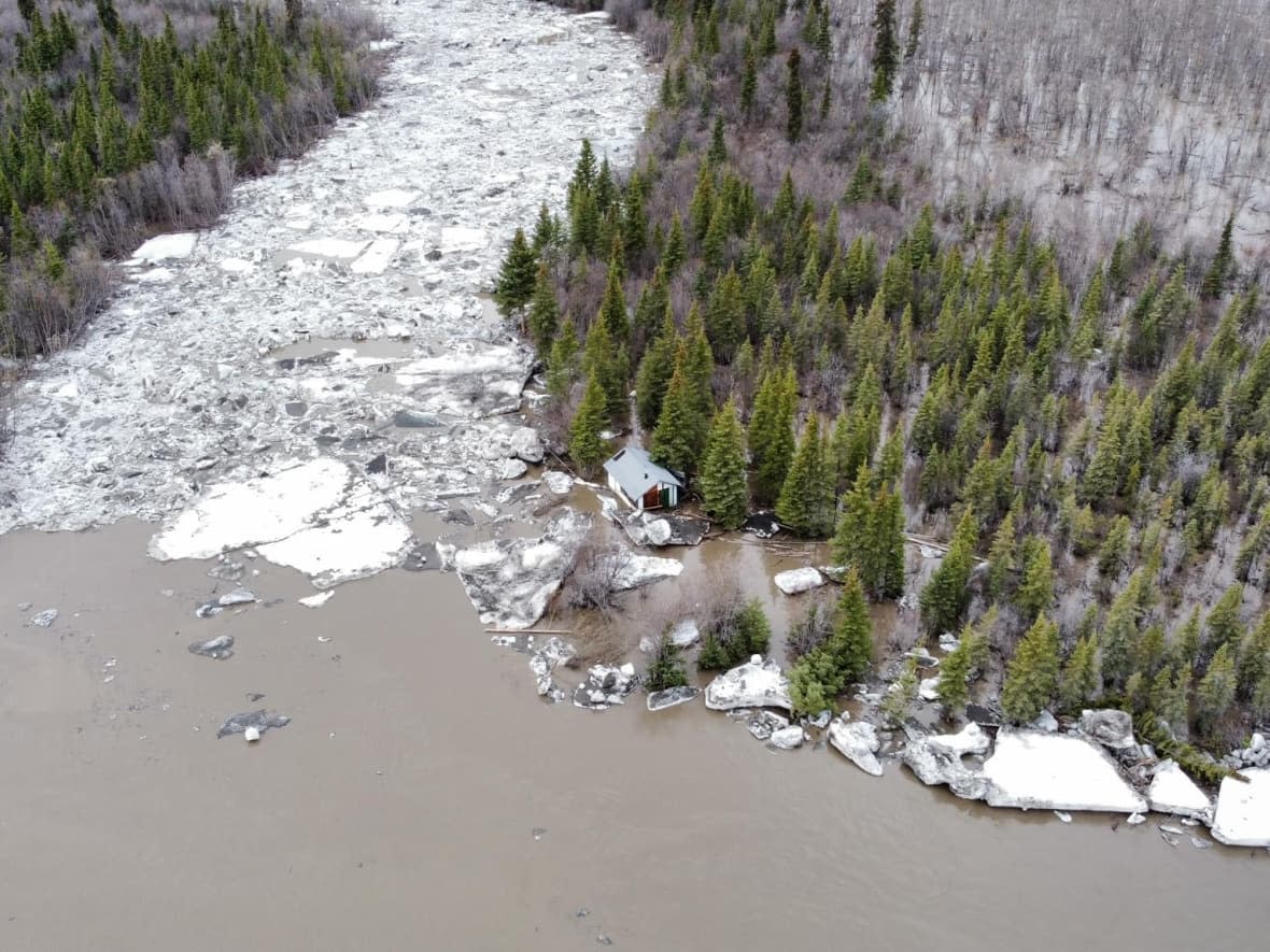 A cabin stranded among high water from the Peel River across from Fort McPherson, N.W.T. (Dean Charlie - image credit)