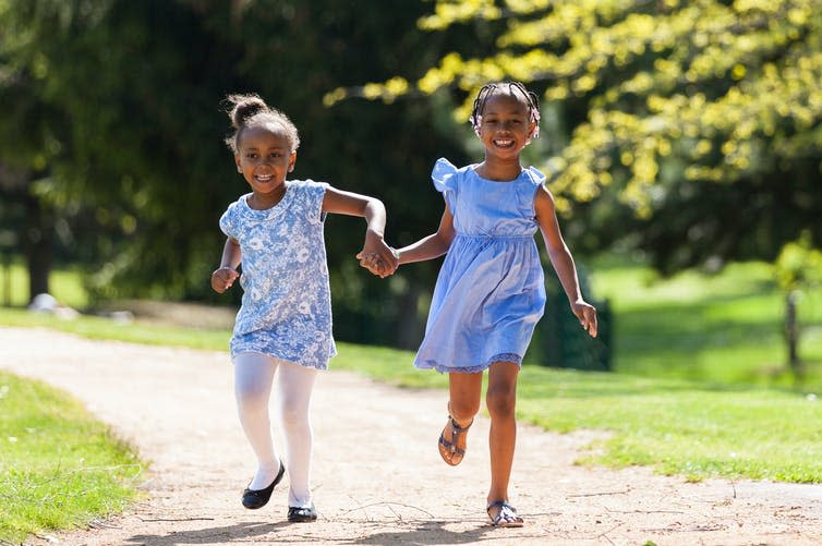 Two girls running outside