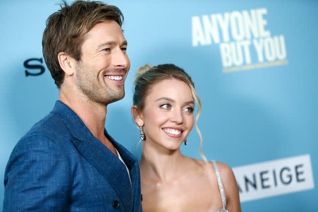 Hearsay about Glen Powell (L) and Sydney Sweeney's purported off-screen romance began circulating when they started filming 