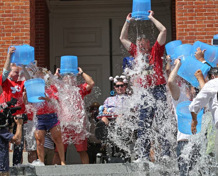 Pete Frates (center) looks on as Massachusetts politicians and state workers join in the Ice Bucket Challenge on Aug. 10, 2015.