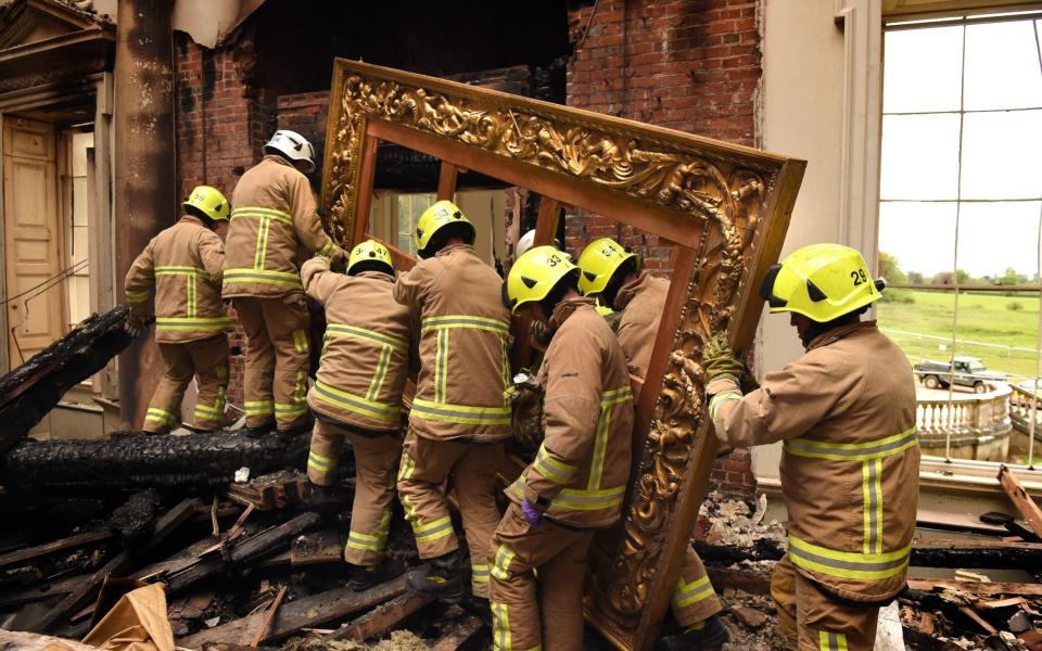 A Picture frame is removed from Clandon Park following the fire - National Trust