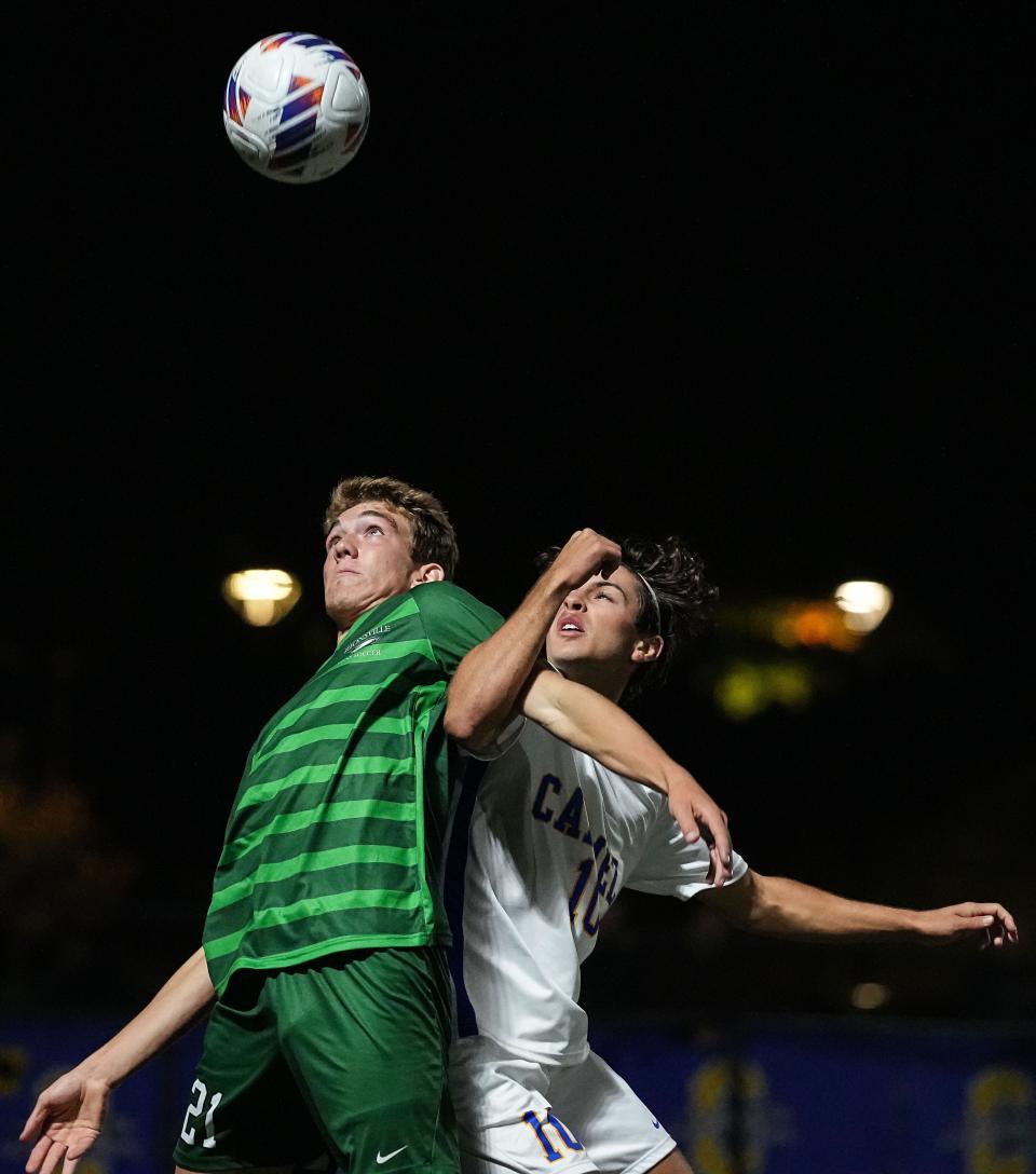Zionsville Eagles Alek Habecker (21) head butts the ball against Carmel Greyhounds Nicolas Basso (10) on Tuesday, Oct. 4, 2022, at Carmel High School in Indianapolis. Carmel Greyhounds defeated the Zionsville Eagles, 2-0. 