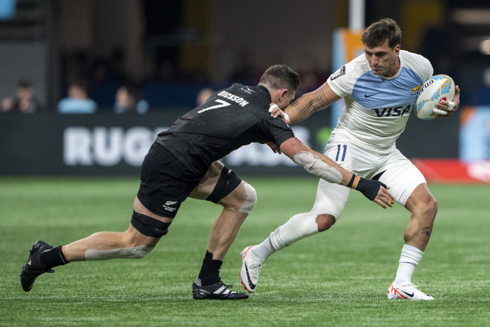 New Zealand's Sam Dickson tries to tackle Argentina's Luciano Gonzalez during then gold medal Vancouver Sevens rugby game, in Vancouver, British Columbia on Sunday, Feb. 25, 2024. (Ethan Cairns/The Canadian Press via AP)