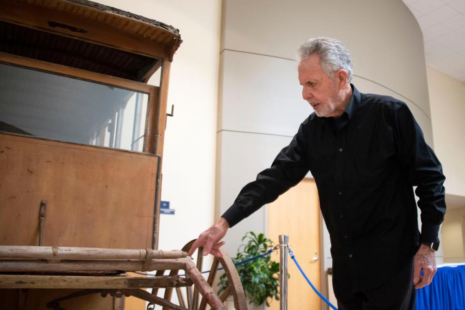 Philantropist Gene Epstein fields questions in front of the old milk wagon he won the bid for, inside Zlock Performing Arts Center at Bucks County Community College on Thursday, Jan. 12, 2022.