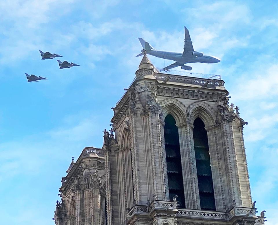 Military planes fly over Notre Dame Cathedral in Paris during Bastille Day July 14, 2022.