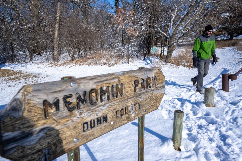 Thomas Pearson walks in Menomin Park on Friday, February 16, 2024, in Menomonie, Wisconsin. The park is adjacent to 3M's 712,000 square foot plant. Groundwater near the 3M plant on the edge of the Dunn County city has tested positive for PFAS, although none has been found in municipal wells. PFAS chemicals, a group of more than 10,000 compounds, are widely used in consumer products, including rain jackets, nonstick pots and pans, and waterproof mascara. They get into the environment through manufacturing, industrial waste, landfills and the use of firefighting foam.