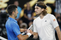 Novak Djokovic of Serbia, left, shakes hands with Stefanos Tsitsipas of Greece after Djokovic won the men's singles final at the Australian Open tennis championships in Melbourne, Australia, Sunday, Jan. 29, 2023. (AP Photo/Asanka Brendon Ratnayake)