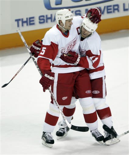 Detroit Red Wings defenseman Nicklas Lidstrom (5), of Sweden, is congratulated by right wing Daniel Cleary (11) after scoring against the San Jose Sharks in the first period of Game 3 of their second-round NHL hockey playoff series in San Jose, Calif., Monday, April 30, 2007. (AP Photo/Paul Sakuma)