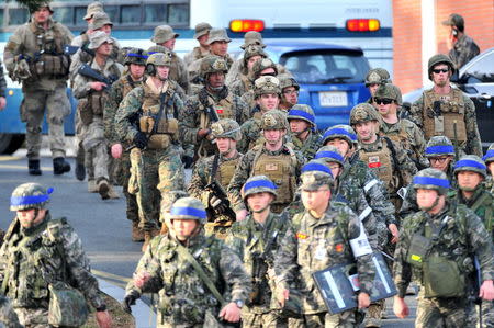 U.S. and South Korean (blue head bands) marines take part in a U.S.-South Korea joint landing operation in Pohang, South Korea, March 7, 2016. REUTERS/Choi Chang-ho/News1