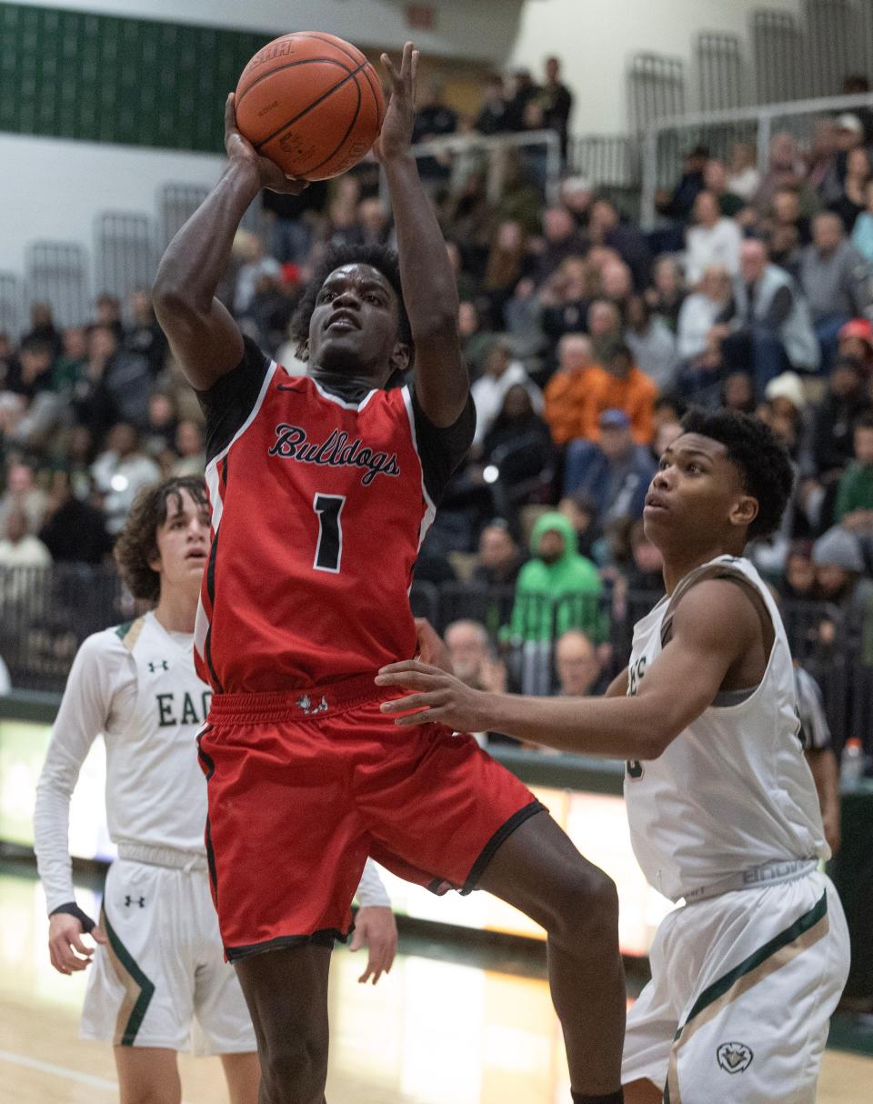 McKinley's Je'Cis Moody shoots with pressure from GlenOak's William Knowles in the second half at GlenOak Thursday. December 14, 2023.