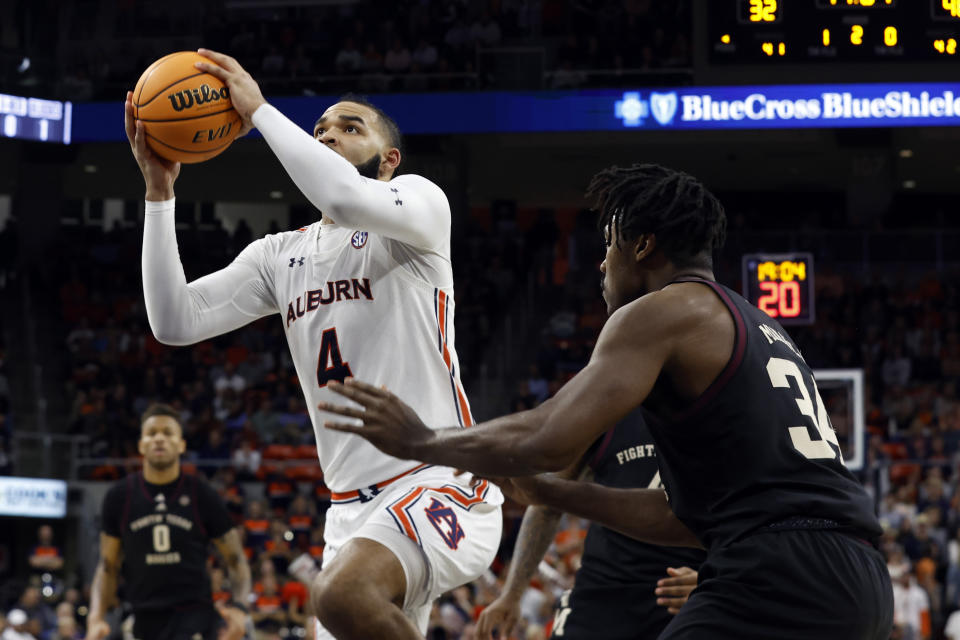 Auburn forward Johni Broome (4) drives to the basket around Texas A&M forward Julius Marble (34) during the second half of an NCAA college basketball game Wednesday, Jan. 25, 2023, in Auburn, Ala.. (AP Photo/Butch Dill)