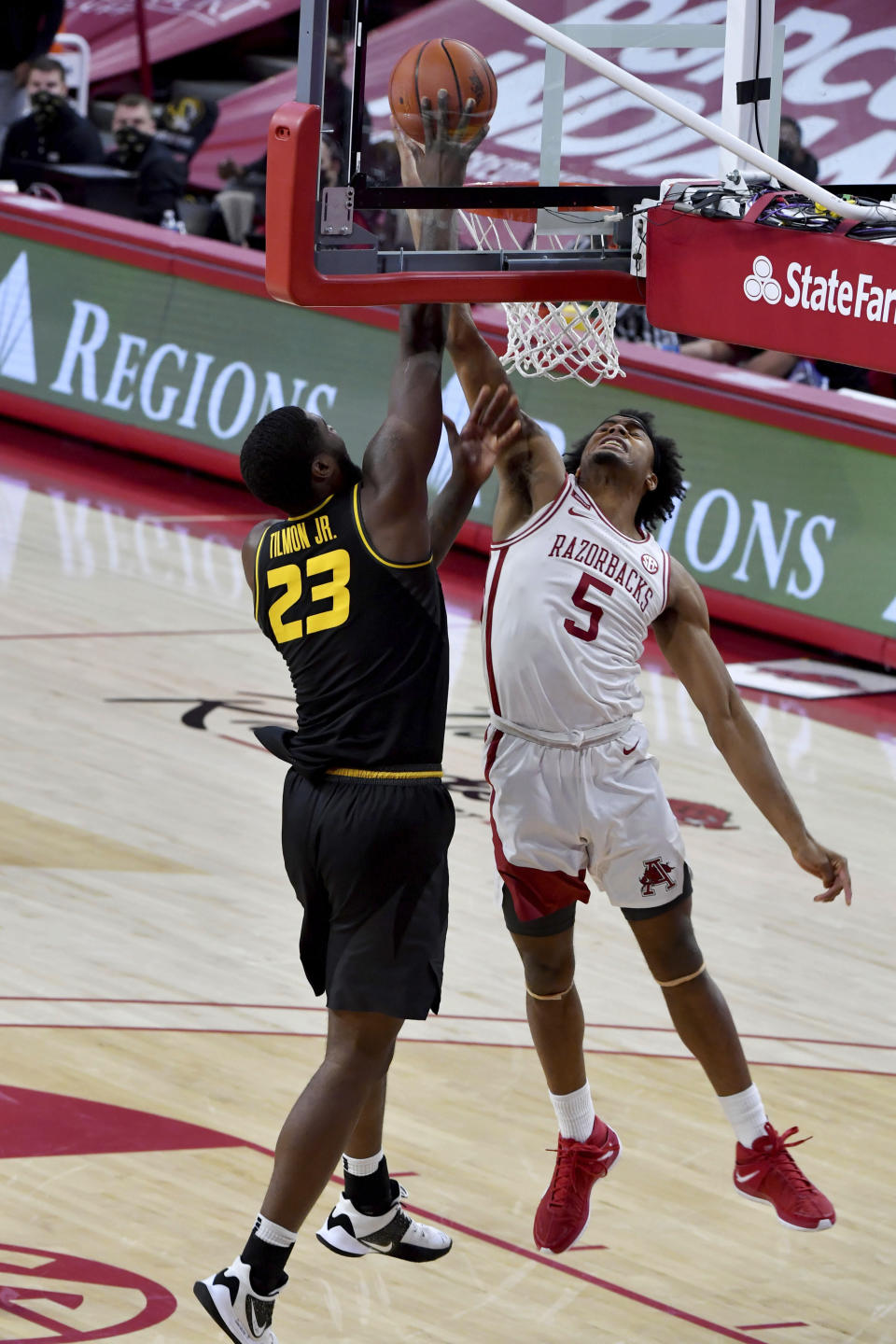 Arkansas defender Moses Moody (5) blocks the shot of Missouri forward Jeremiah Tilmon (23) during the first half of an NCAA college basketball game in Fayetteville, Ark. Saturday, Jan. 2, 2021. (AP Photo/Michael Woods)