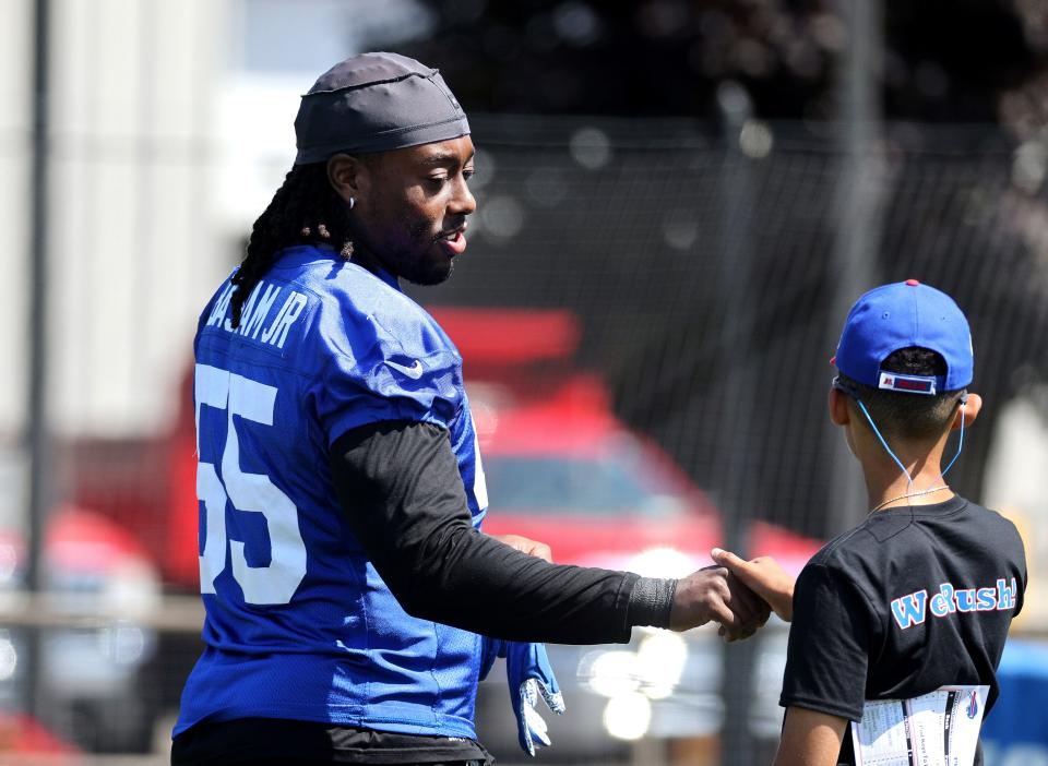 Bills edge rusher Boogie Basham is greeted before practice.