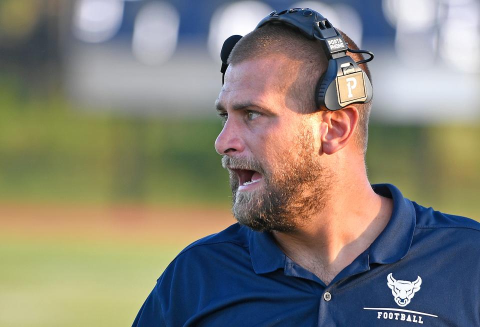 Parrish Community High School's new head football coach, Robert Dylan Clark strategically barks orders from the sidelines. Parrish Community Bulls wins big 43-0 over the North Port Bobcats during a home game played at Parrish Community High School in Parrish, Friday night, August 25, 2023.