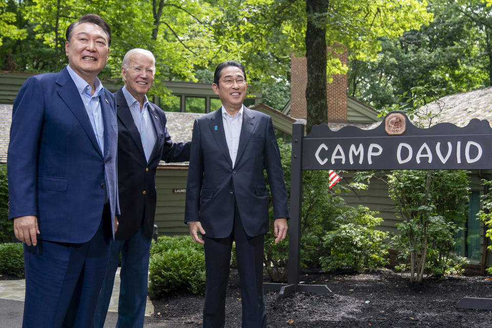 FILE - President Joe Biden greets South Korea's President Yoon Suk Yeol, left, and Japan's Prime Minister Fumio Kishida, right, Friday, Aug. 18, 2023, at Camp David, the presidential retreat, near Thurmont, Md. North Korea has told Japan it plans to launch a satellite in the coming days, a possible second try to put a military spy satellite into orbit, Japanese media said Tuesday, Aug. 22. (AP Photo/Andrew Harnik, File)
