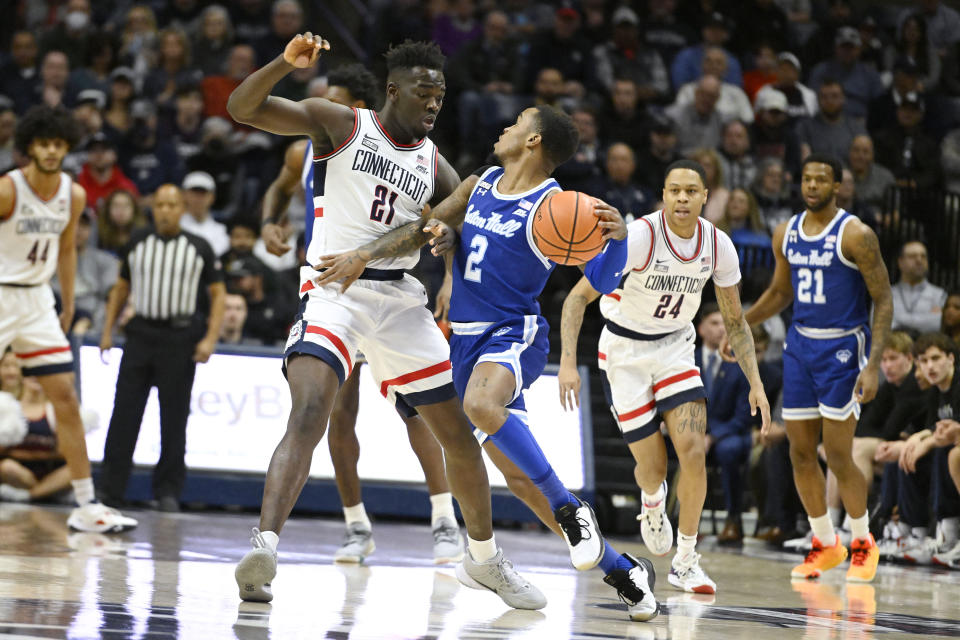 Seton Hall's Al-Amir Dawes (2) is guarded by UConn's Adama Sanogo (21) in the first half of an NCAA college basketball game, Saturday, Feb. 18, 2023, in Storrs, Conn. (AP Photo/Jessica Hill)