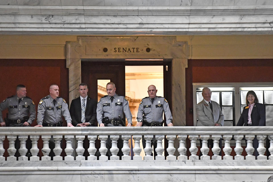 Members of the Kentucky State Police look out over the protesters gathered outside the Senate chambers of the Kentucky State Capitol in Frankfort, Ky., Wednesday, March 29, 2023. Protesters gathered outside the chambers to show their opposition of Senate bill SB150, known as the Transgender Health Bill. (AP Photo/Timothy D. Easley)