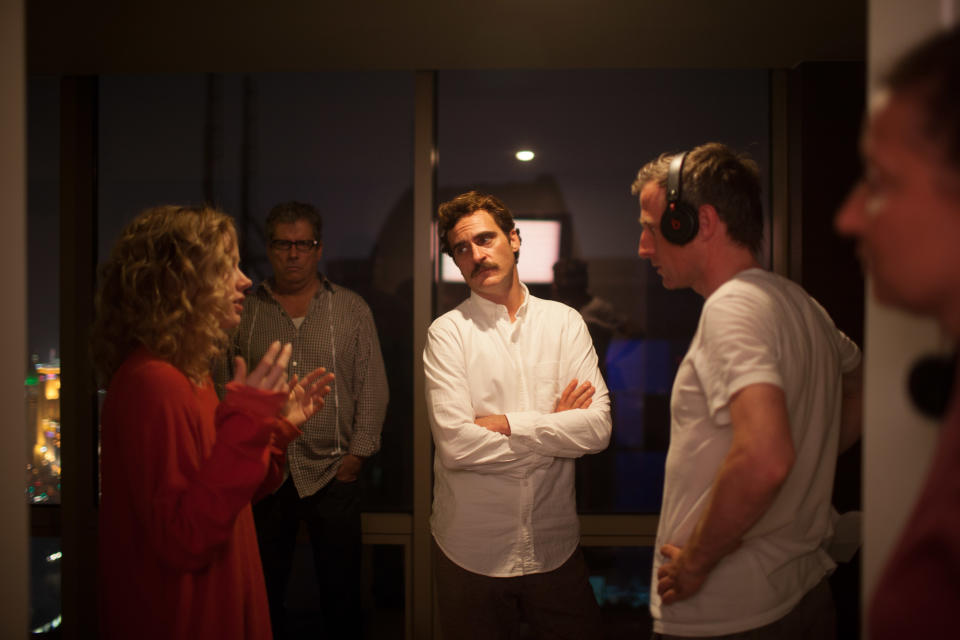 This image released by Warner Bros. Pictures shows Amy Adams, left, Joaquin Phoenix, center, and director Spike Jonze on the set of "Her." The film has been selected as the best film of the year by the National Board of Review and Phoenix was nominated for a Golden Globe for best actor in a motion picture musical or comedy. (AP Photo/Warner Bros. Pictures, Sam Zhu)