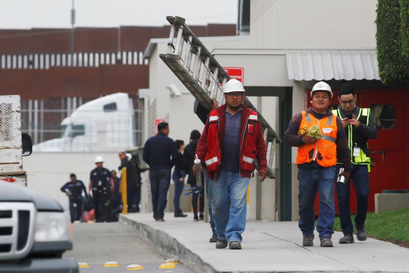 Workers are seen while leaving Plantronics, an electronic components manufacturing company, at the Otay industrial park in Tijuana