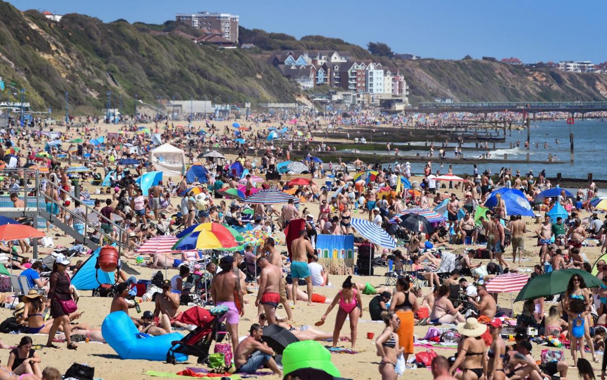 Tourists enjoy the hot weather at Bournemouth beach on May 25, 2020 in Bournemouth, United Kingdom - GETTY IMAGES